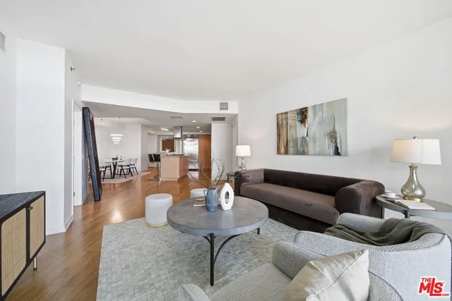 a living room with lots of furniture and kitchen view