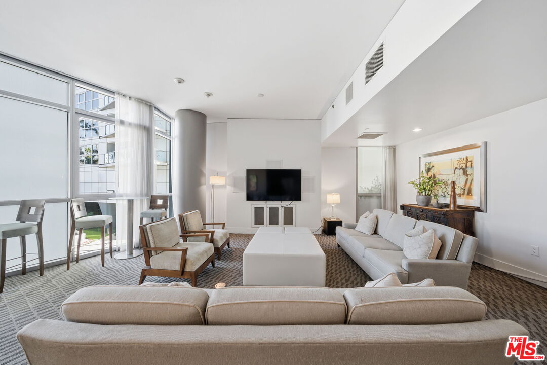 13650 Marina Pointe Drive, Unit 1603 Marina del Rey, CA 90292 - Photo 64 of 75 a living room with furniture and a flat screen tv