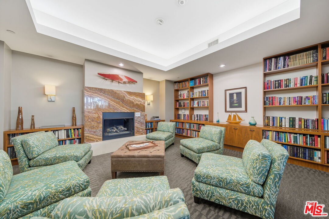 13650 Marina Pointe Drive, Unit 1603 Marina del Rey, CA 90292 - Photo 67 of 75 a living room with furniture and a fireplace