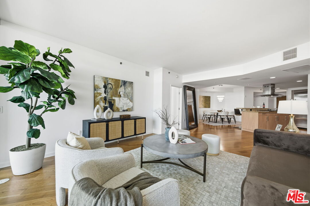 13650 Marina Pointe Drive, Unit 1603 Marina del Rey, CA 90292 - Photo 7 of 75 a living room with furniture a potted plant and a table