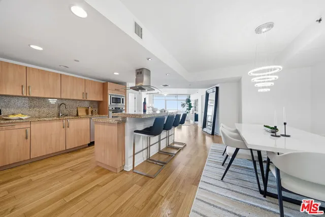 a kitchen with stainless steel appliances granite countertop a sink stove and cabinets