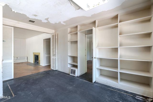 a view of an empty room with a closet