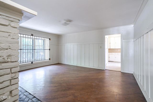 wooden floor in an empty room with a window
