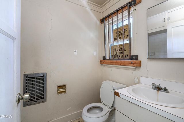 a view of a livingroom with wooden floor and a window
