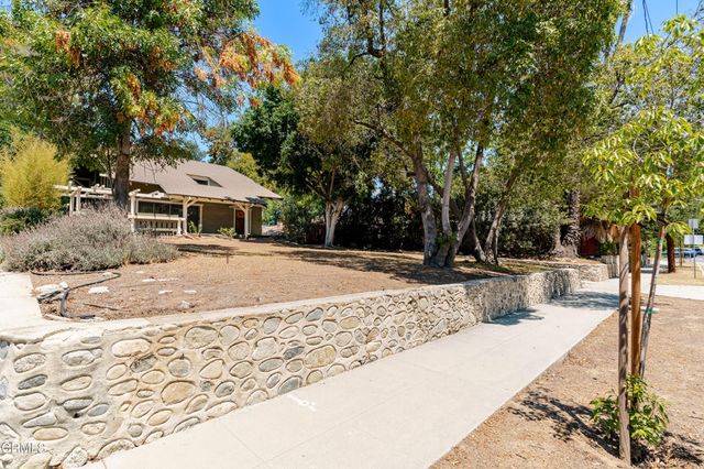 a view of a white house with a snow on the road