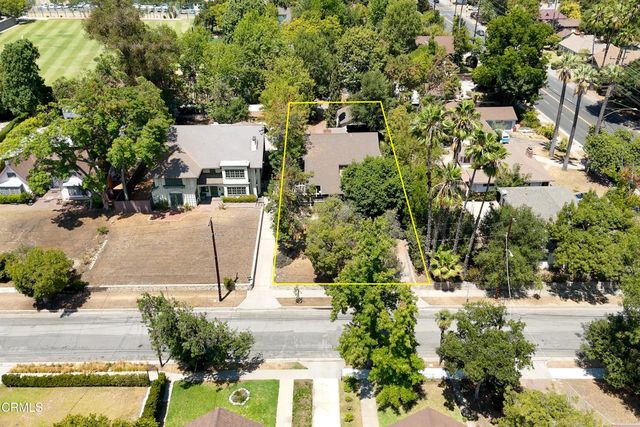 an aerial view of residential house with outdoor space and trees all around