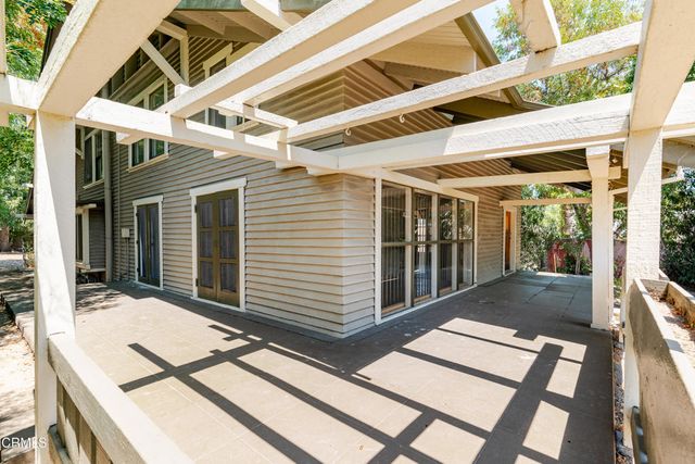 a view of balcony with wooden floor and door