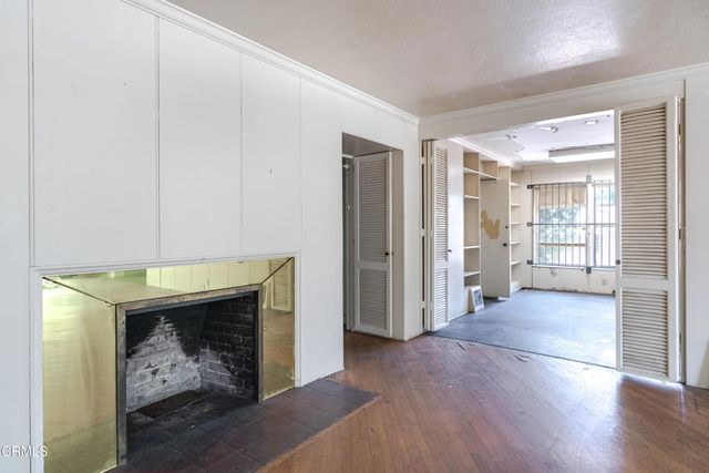 a view of an empty room with a fireplace