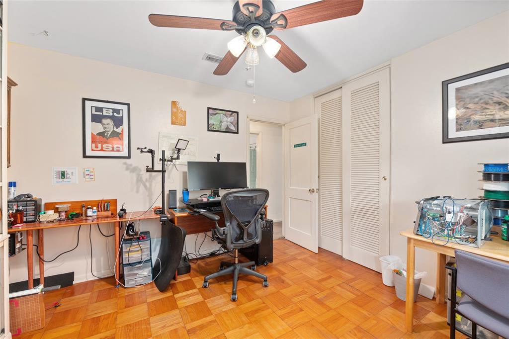 3018 Northwest 2nd Avenue Gainesville, FL 32607 - Photo 14 of 21 a view of a workspace with furniture and a bedroom
