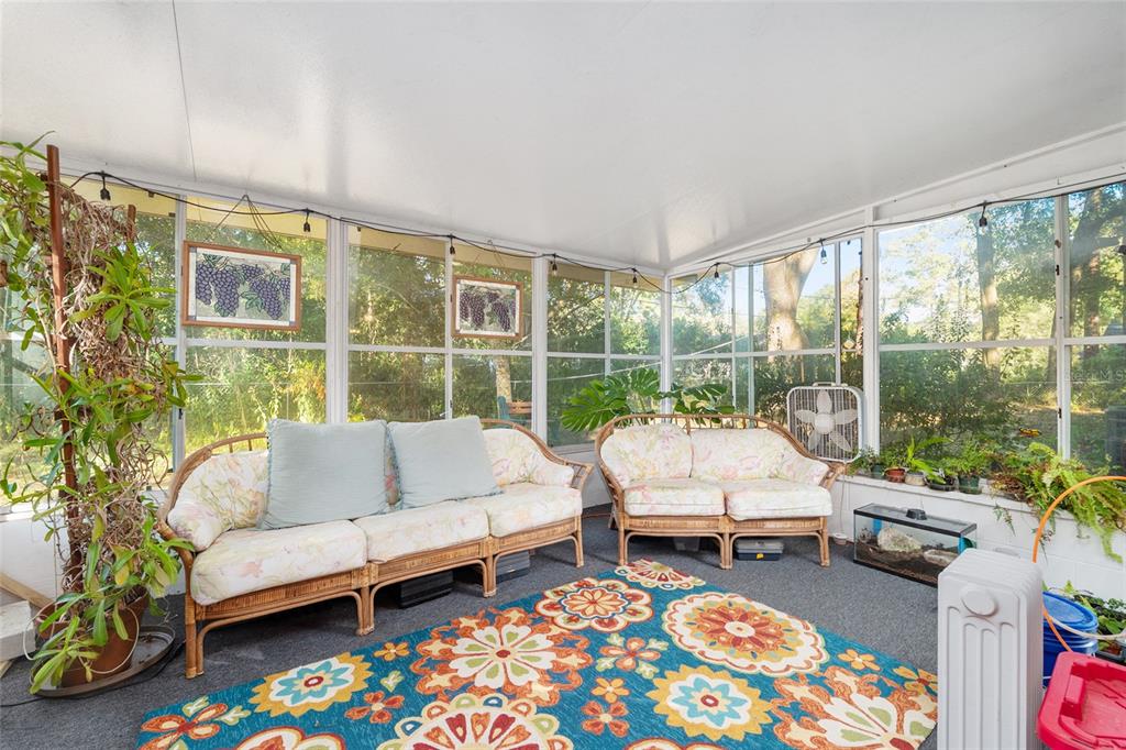 3018 Northwest 2nd Avenue Gainesville, FL 32607 - Photo 17 of 21 a living room with furniture and a floor to ceiling window