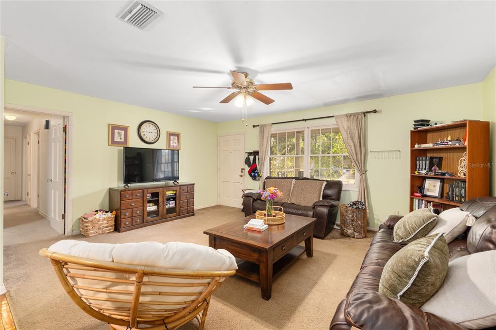 3018 Northwest 2nd Avenue Gainesville, FL 32607 - Photo 5 of 21 a living room with furniture a flat screen tv and a large window