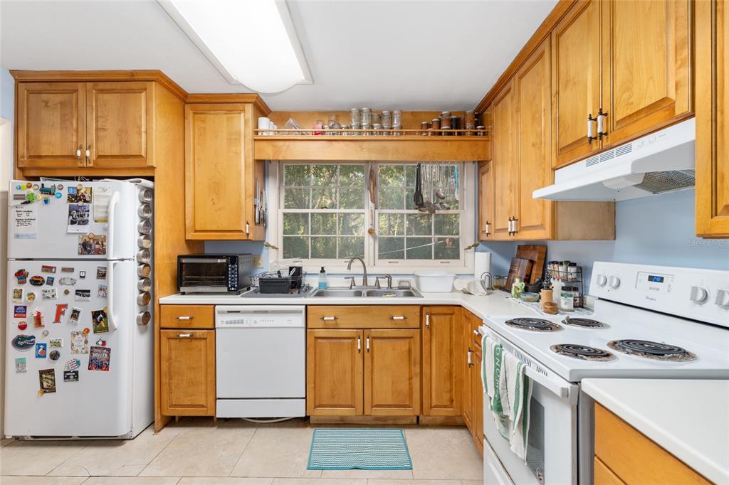 3018 Northwest 2nd Avenue Gainesville, FL 32607 - Photo 9 of 21 a kitchen with a sink a stove and cabinets