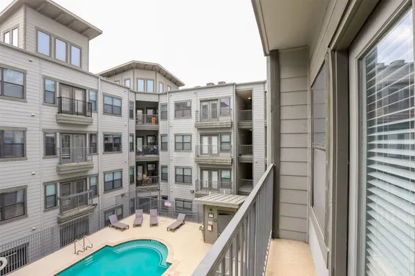 a balcony with a table and chairs