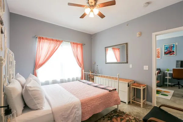 a bedroom with a bed and a window