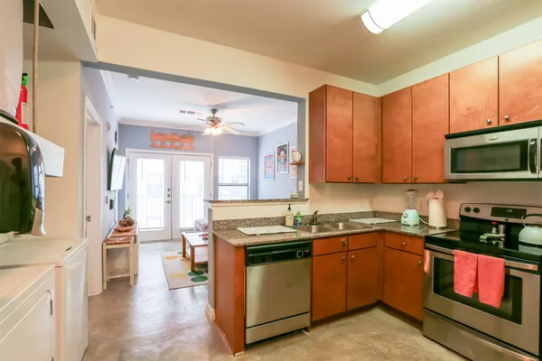 a kitchen with a sink stove and microwave