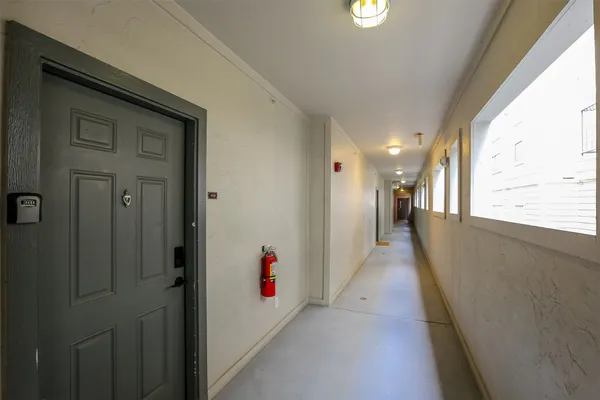a view of a hallway with wooden shelves
