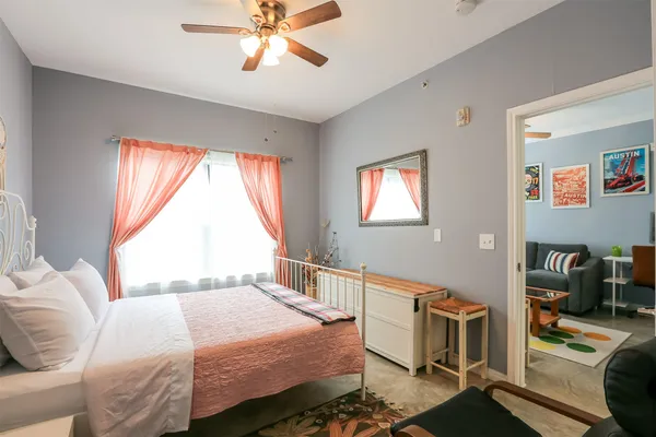 a bedroom with a bed and wooden floor