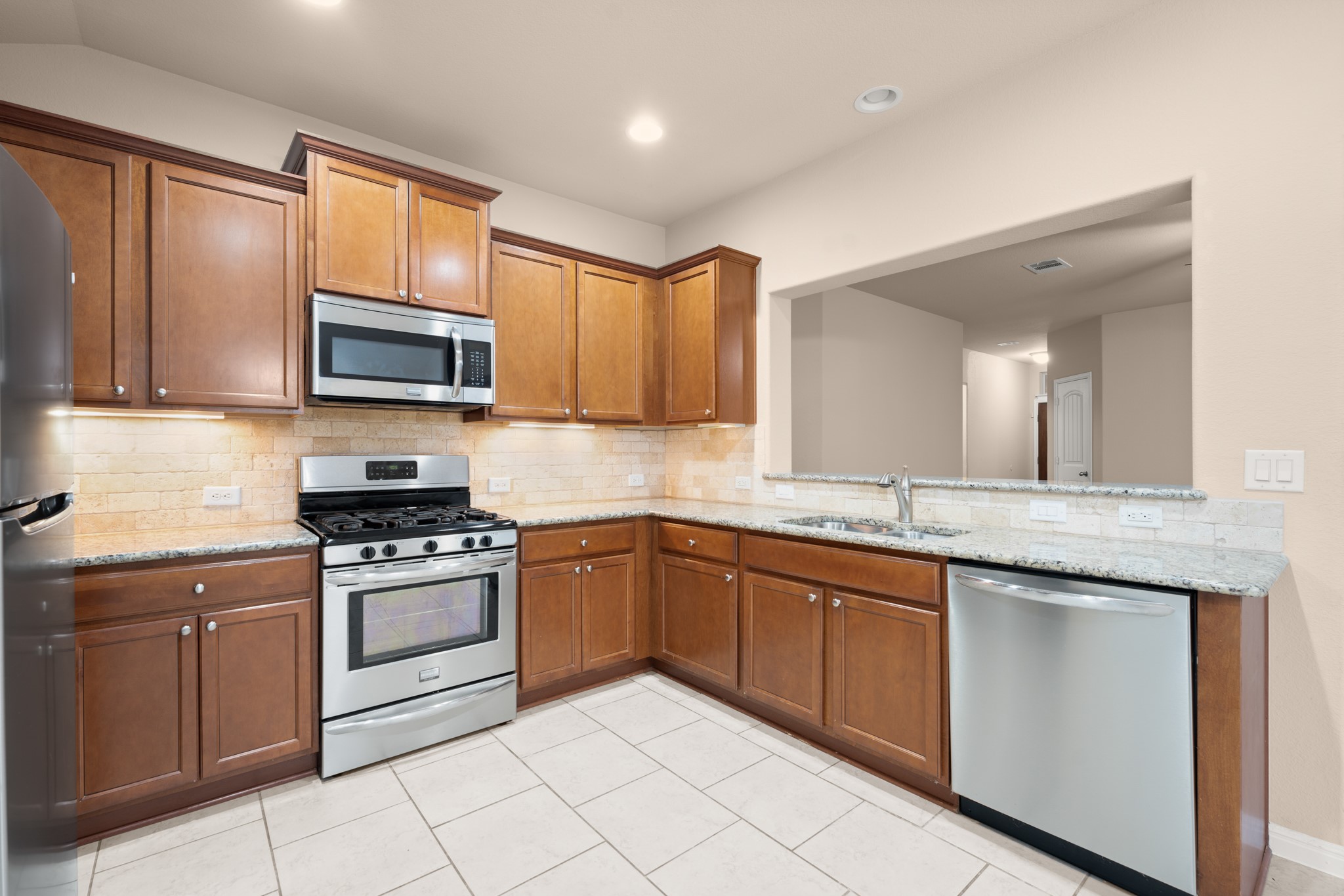 305 Longhorn Cavern Road Leander, TX 78641 - Photo 5 of 21 Love the granite countertops and the subway tile backsplash—it’s the perfect blend of style and durability.