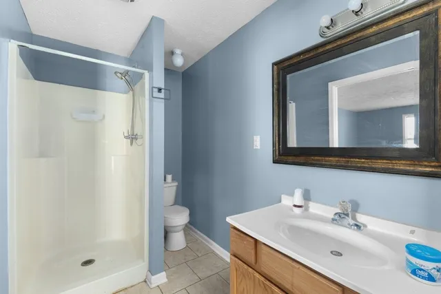 a bathroom with a sink mirror and a shower
