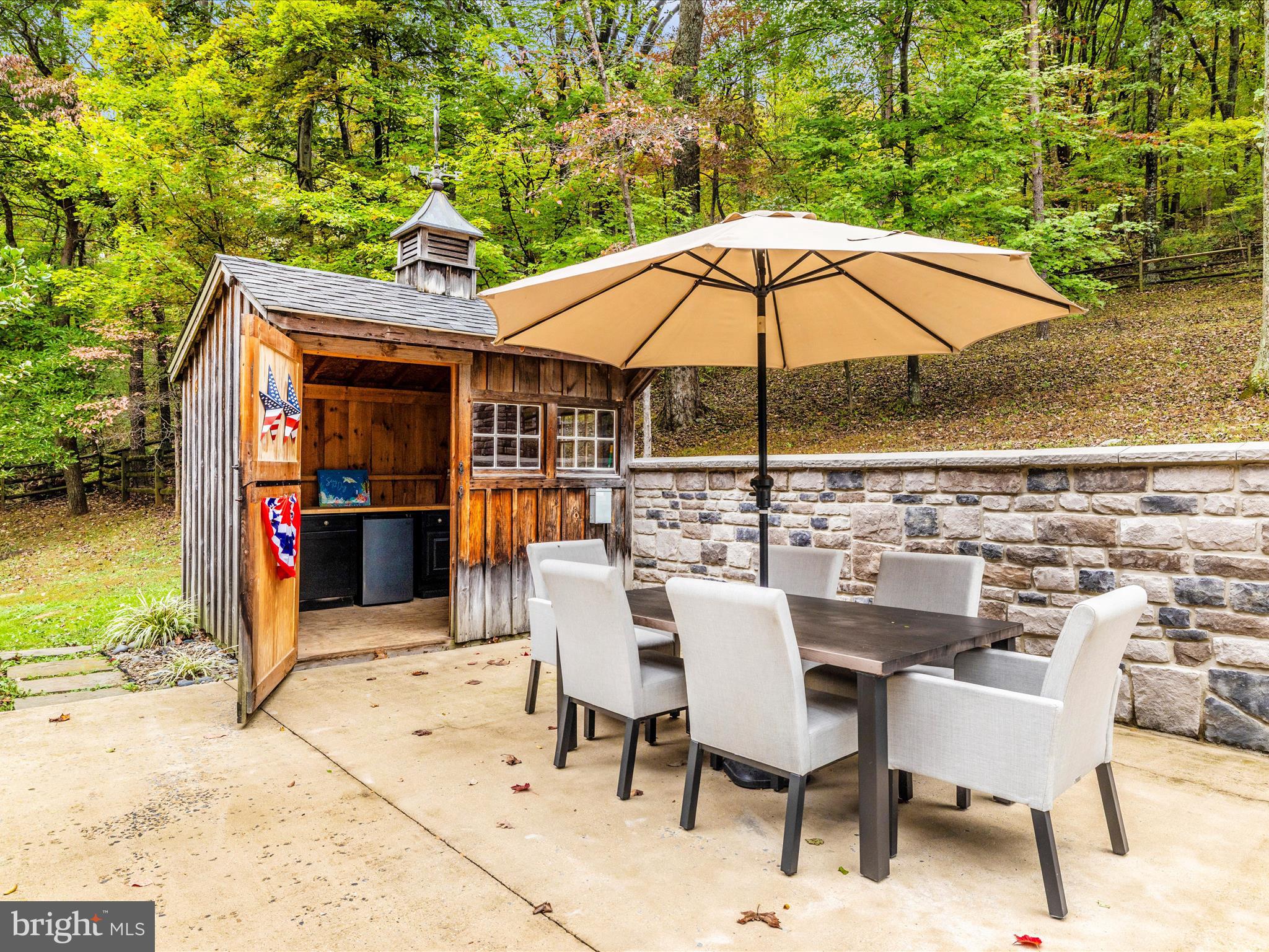 8935 Hawbottom Road Middletown, MD 21769 - Photo 70 of 84 a view of a roof deck with table and chairs under an umbrella