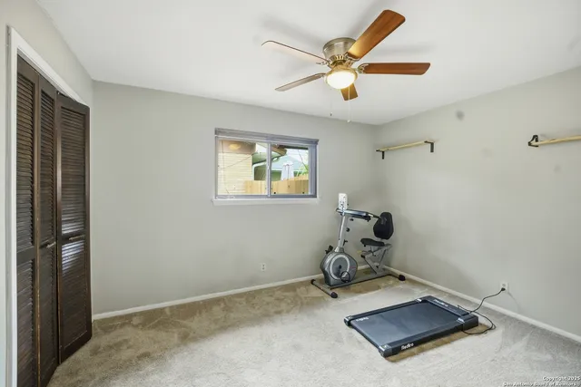 a room with gym equipment and view of living room