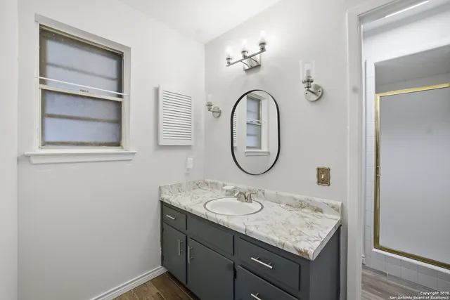 a bathroom with a sink and a mirror
