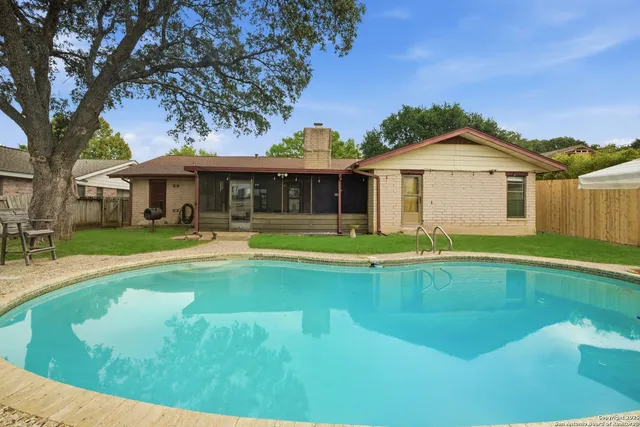 a view of an house with swimming pool and porch