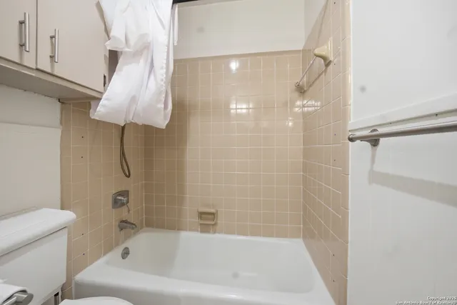 a bathroom with a bathtub and shower