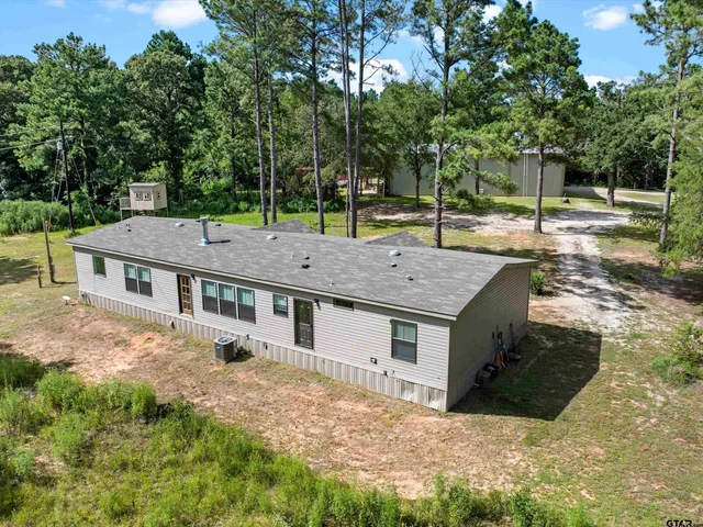 a aerial view of a house with a yard