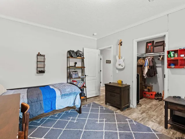 a living room with a bed and a dresser