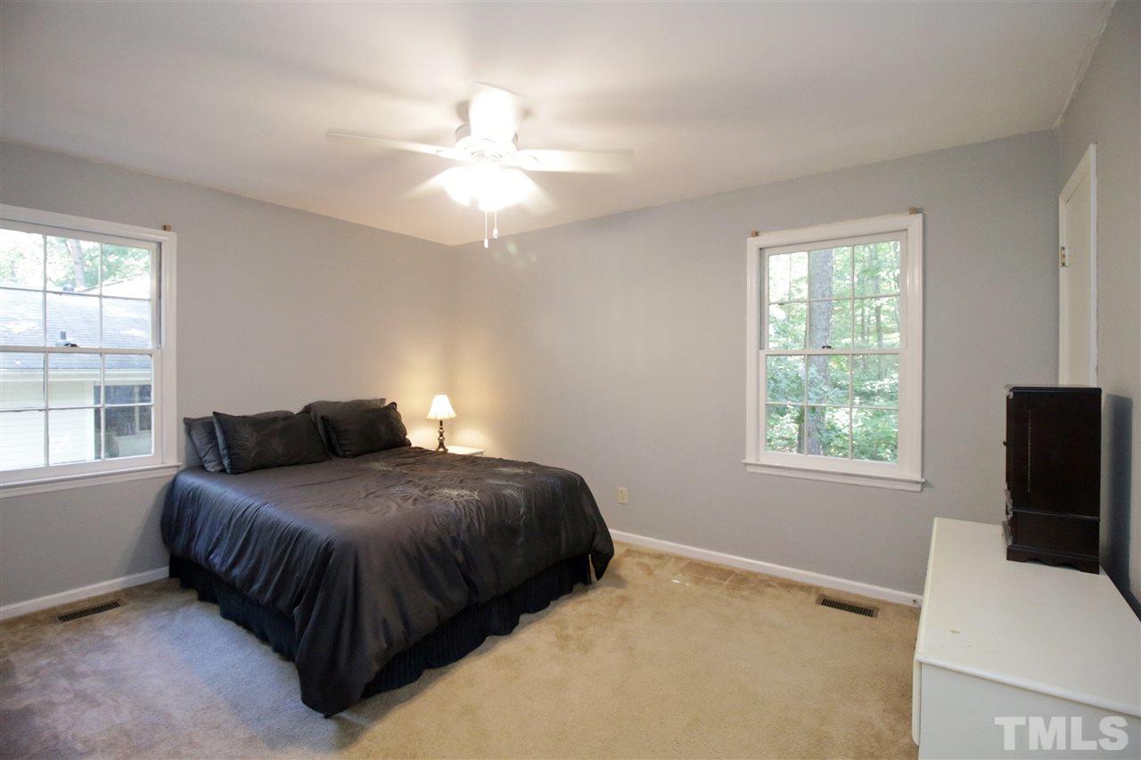 7420 Post Oak Road Raleigh, NC 27615 - Photo 11 of 22 a bedroom with a bed flat screen tv and window