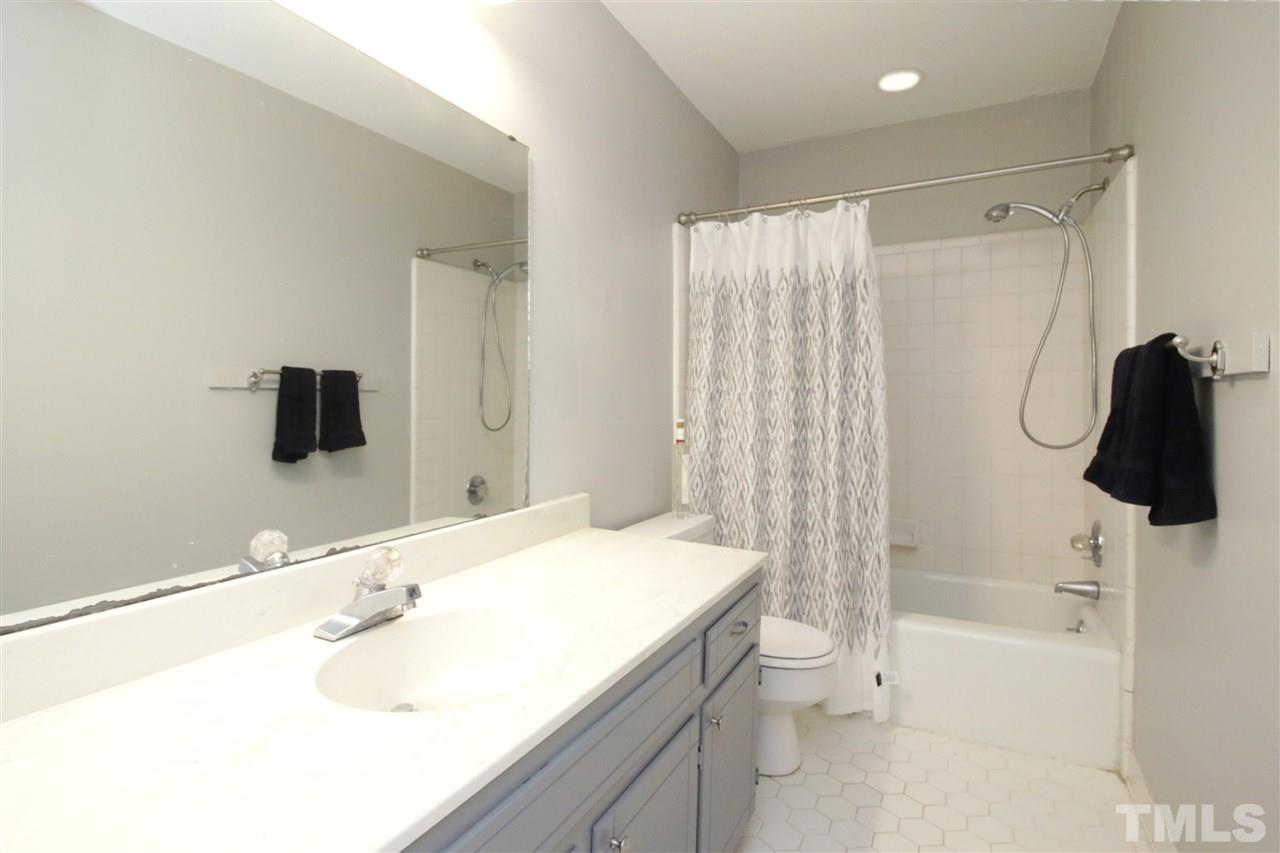 7420 Post Oak Road Raleigh, NC 27615 - Photo 15 of 22 a bathroom with a sink a toilet and shower