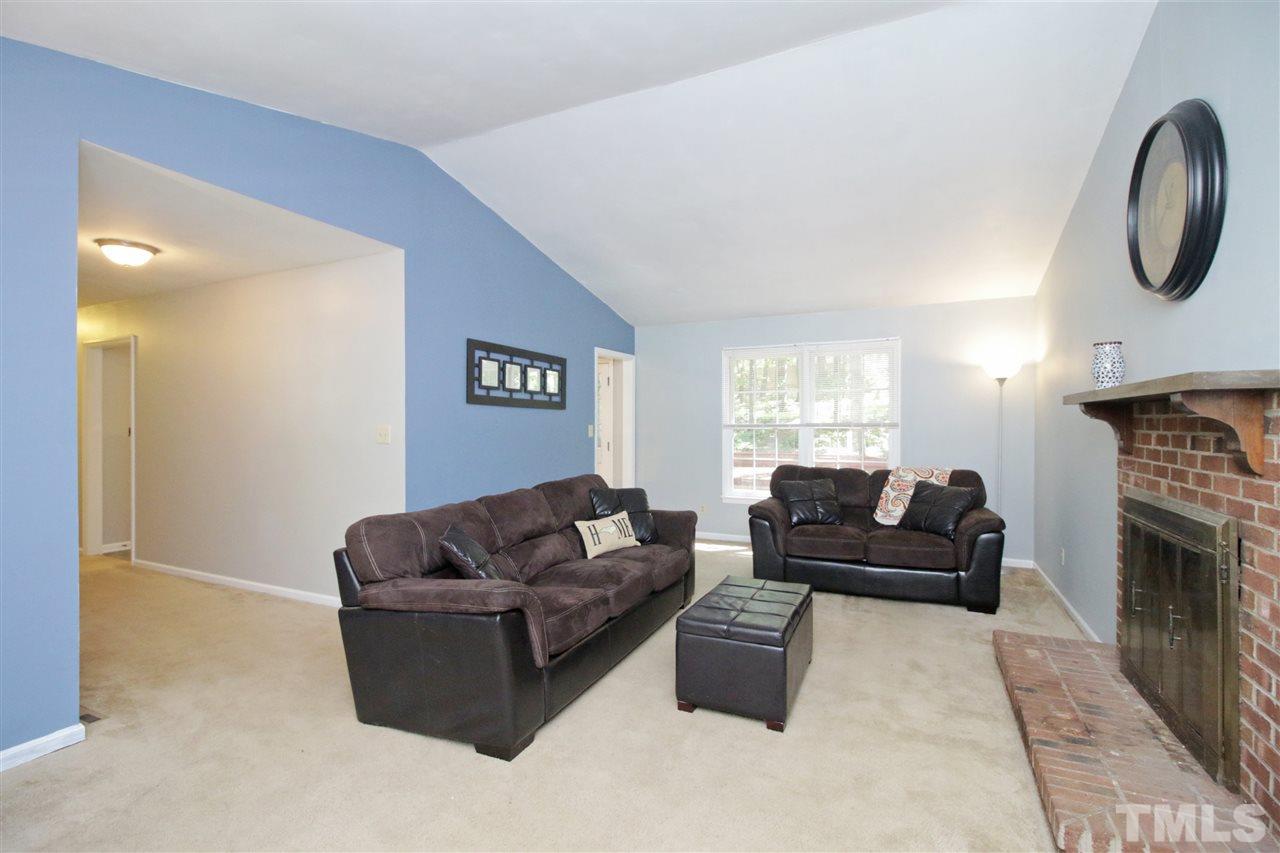 7420 Post Oak Road Raleigh, NC 27615 - Photo 4 of 22 a living room with furniture and a fireplace