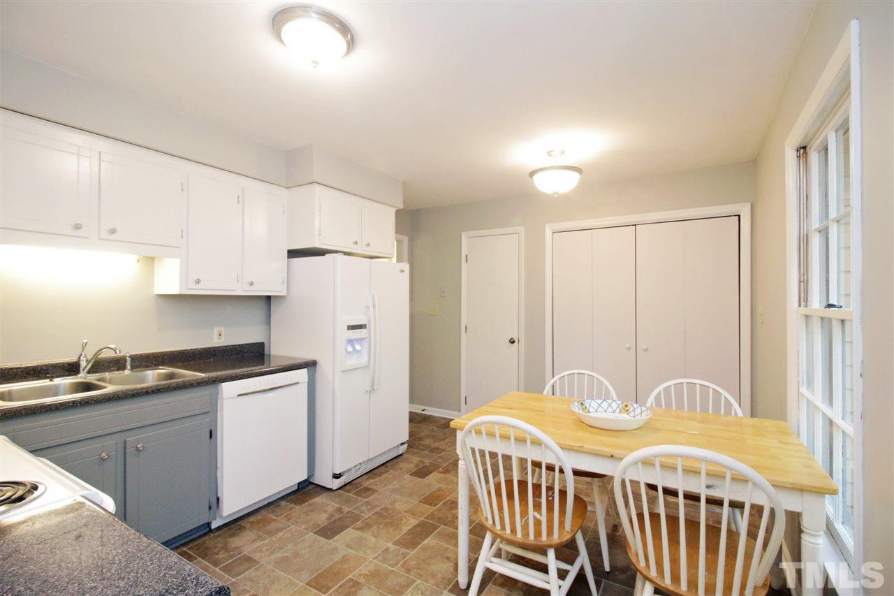 7420 Post Oak Road Raleigh, NC 27615 - Photo 10 of 22 a kitchen with stainless steel appliances granite countertop a white cabinets and a refrigerator
