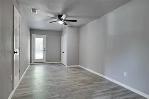 a view of an empty room and wooden floor