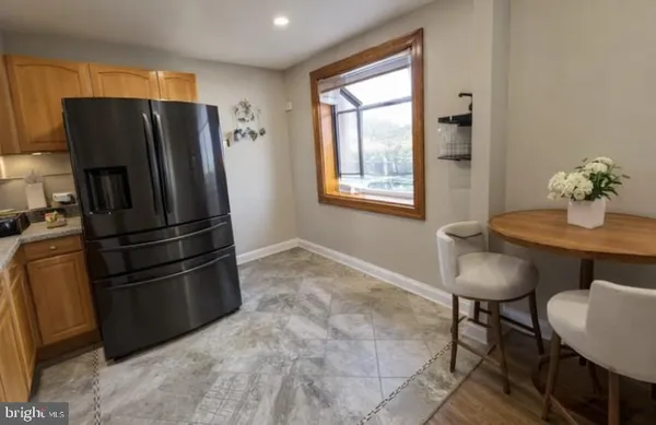 a kitchen with stainless steel appliances granite countertop a refrigerator and a table