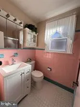 a bathroom with a sink toilet and mirror