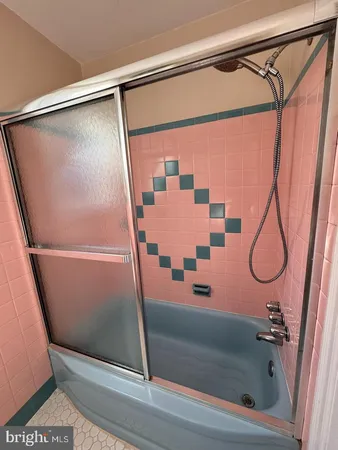 a bathroom with a shower and a tub