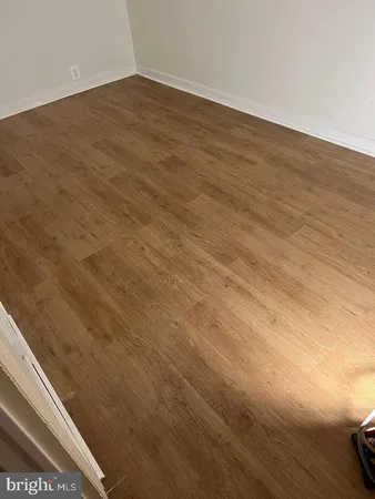 a view of wooden floor and brick wall