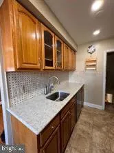 a kitchen with stainless steel appliances granite countertop a sink and a refrigerator