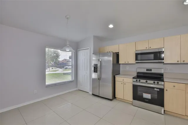 a kitchen with stainless steel appliances a refrigerator stove and microwave