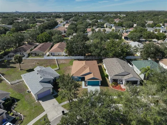 an aerial view of a house with yard swimming pool and outdoor seating
