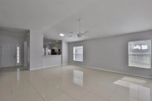 an empty room with windows and entrance