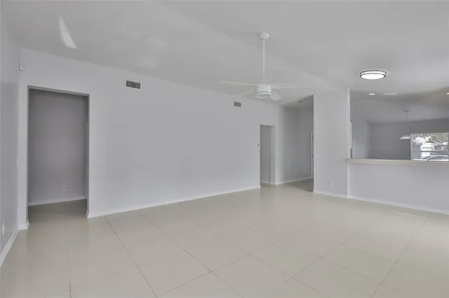 an empty room with entrance and windows