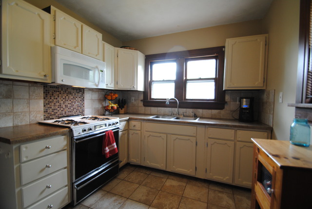 1120 Ridgeway Avenue Aurora, IL 60506 - Photo 3 of 16 a kitchen with stainless steel appliances granite countertop a sink stove and cabinets