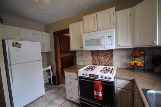 1120 Ridgeway Avenue Aurora, IL 60506 - Photo 4 of 16 a kitchen with stainless steel appliances granite countertop a stove a refrigerator and a stove