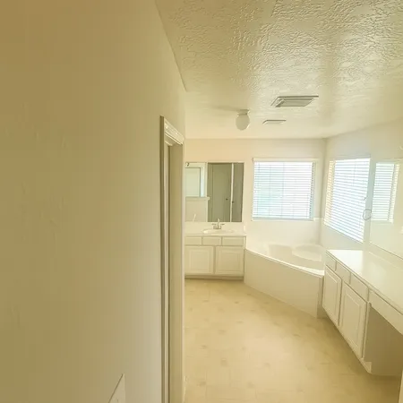 a bathroom with a bathtub and mirror