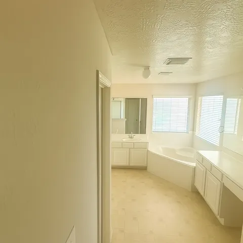 a bathroom with a bathtub and mirror