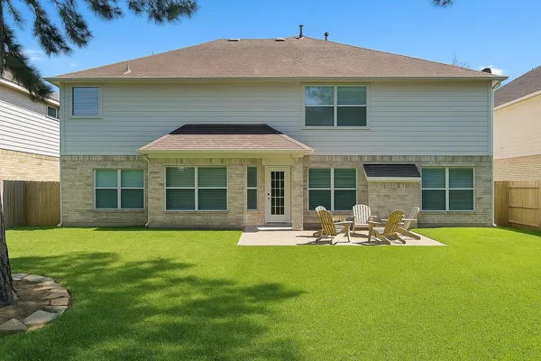 a front view of a house with a yard and porch