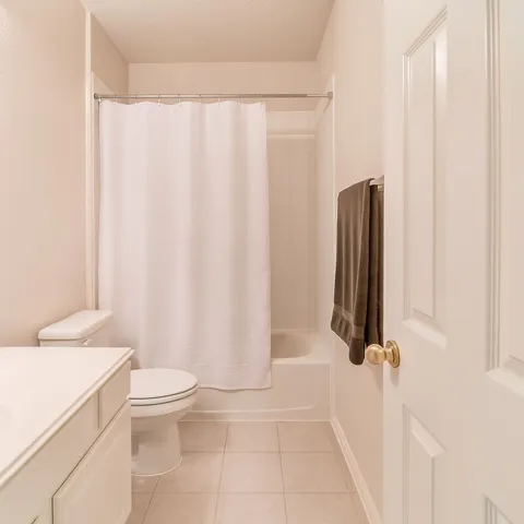 a bathroom with a shower curtain and a sink